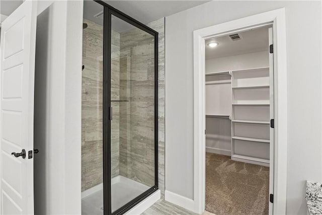 1440 Amber Way, Centerton, AR 72719 - bathroom featuring a stall shower, a spacious closet, and baseboards
