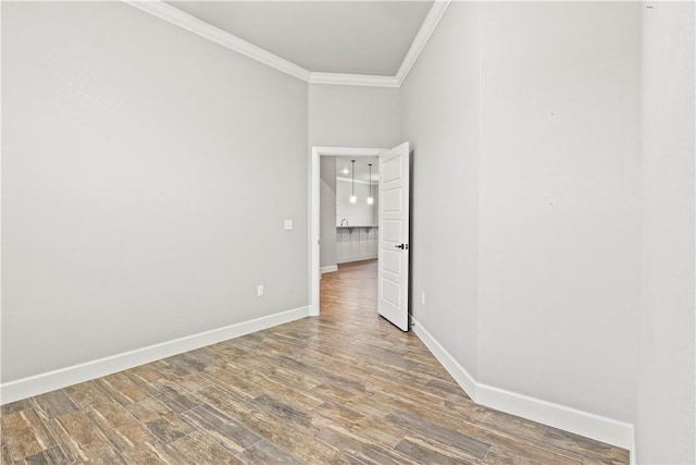 1440 Amber Way, Centerton, AR 72719 - spare room featuring crown molding, wood finished floors, and baseboards