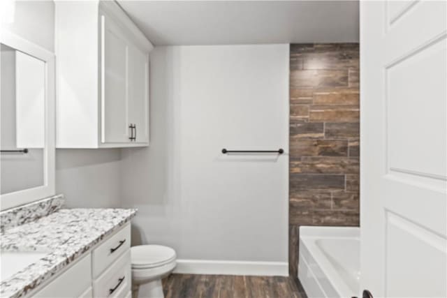 1440 Amber Way, Centerton, AR 72719 - full bathroom with vanity, a bath, wood finished floors, toilet, and baseboards