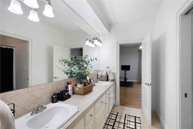 306 Osage Ct, Russellville, AR 72802 - bathroom featuring double vanity, tile patterned flooring, a chandelier, backsplash, and baseboards