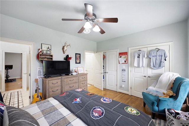 306 Osage Ct, Russellville, AR 72802 - bedroom featuring two closets, light wood-style floors, and ceiling fan