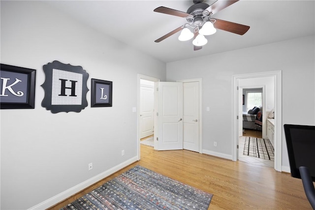 306 Osage Ct, Russellville, AR 72802 - unfurnished bedroom featuring wood finished floors, baseboards, connected bathroom, and ceiling fan