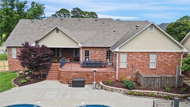 306 Osage Ct, Russellville, AR 72802 - rear view of property with a patio, brick siding, stucco siding, and roof with shingles
