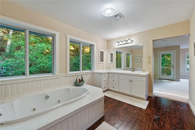 9151 Bay Ridge Ln, Garfield, AR 72732 - full bath with hardwood / wood-style floors, vanity, and a jetted tub