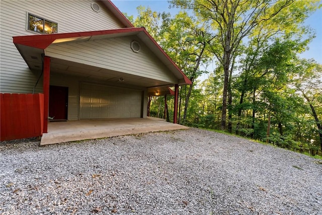 9151 Bay Ridge Ln, Garfield, AR 72732 - view of property exterior with gravel driveway and an attached garage