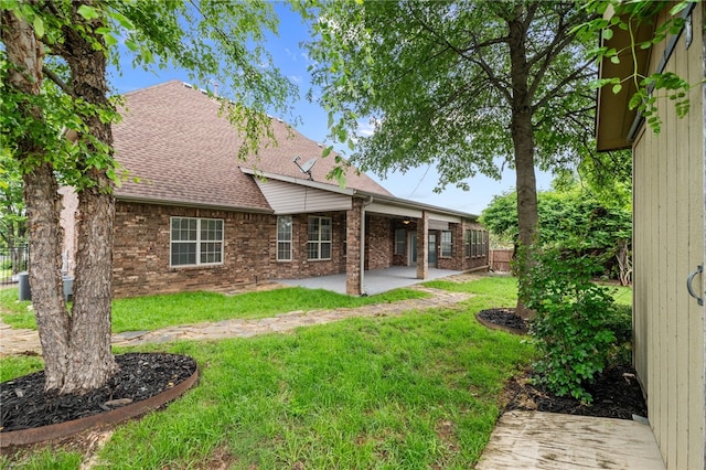 600 Rocky Xing, Fayetteville, AR 72704 - rear view of property featuring brick siding, a shingled roof, and a patio