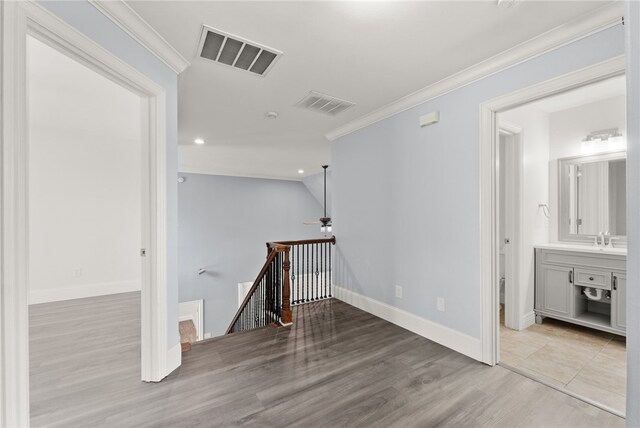 600 Rocky Xing, Fayetteville, AR 72704 - hall featuring an upstairs landing, wood finished floors, ornamental molding, a sink, and baseboards