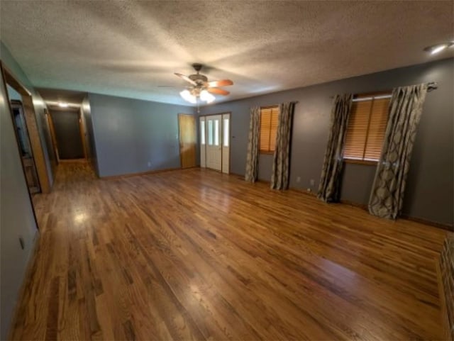 208 Mc 6087, Yellville, AR 72687 - unfurnished bedroom with wood finished floors, a textured ceiling, and a ceiling fan