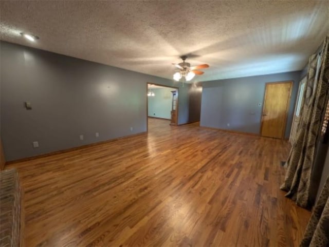 208 Mc 6087, Yellville, AR 72687 - unfurnished room featuring ceiling fan, wood finished floors, a textured ceiling, and baseboards