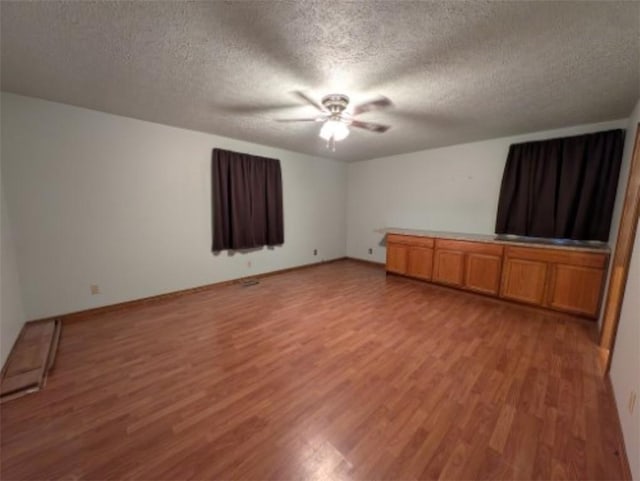 208 Mc 6087, Yellville, AR 72687 - unfurnished living room with light wood-style floors, a ceiling fan, and a textured ceiling