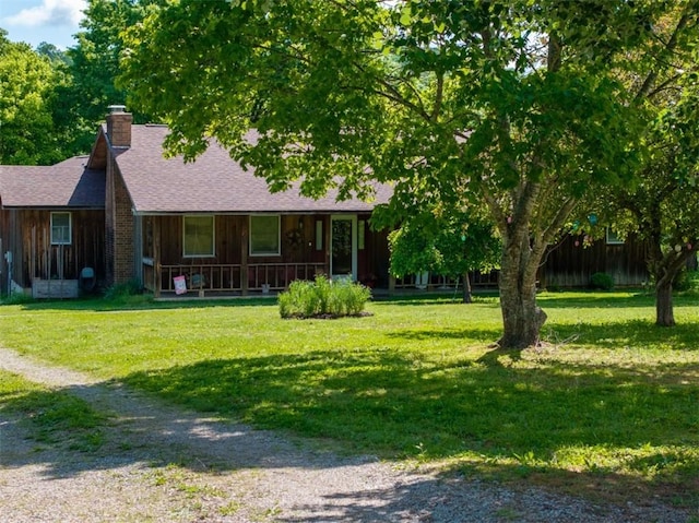 208 Mc 6087, Yellville, AR 72687 - view of front of home featuring covered porch, a chimney, a front yard, a shingled roof, and board and batten siding