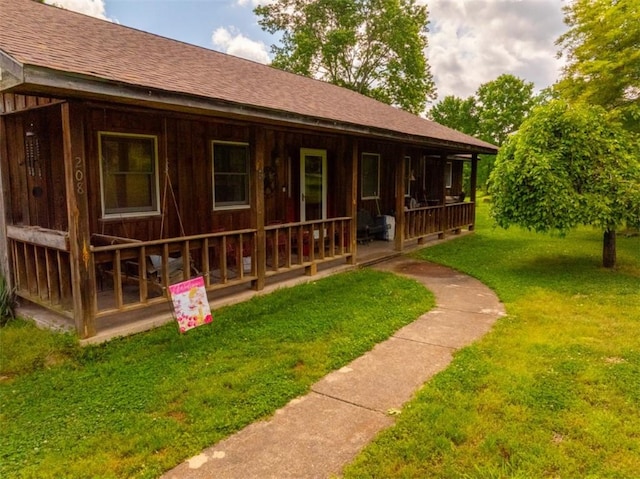 208 Mc 6087, Yellville, AR 72687 - view of front of home featuring a porch, roof with shingles, and a front lawn