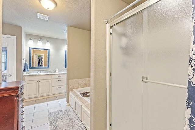 801 SW Castlewood St, Bentonville, AR 72712 - bathroom featuring a stall shower, vanity, a bath, a textured ceiling, and tile patterned flooring