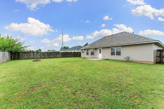 801 SW Castlewood St, Bentonville, AR 72712 - rear view of house featuring a patio and a shingled roof