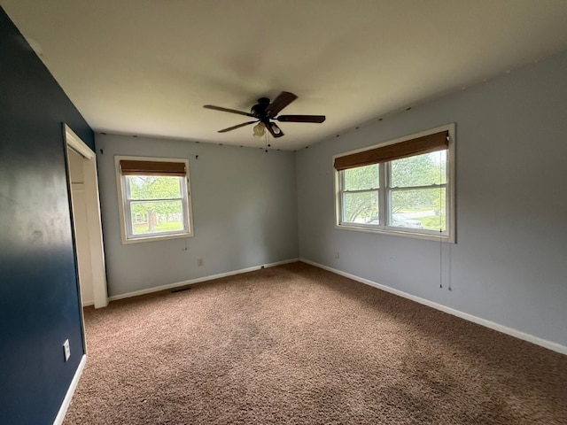 1902 W Granite St, Siloam Springs, AR 72761 - empty room featuring healthy amount of natural light, carpet floors, a ceiling fan, and baseboards