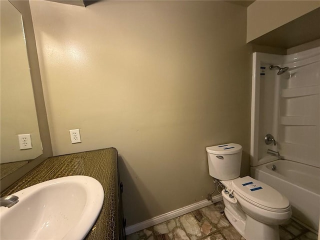 1902 W Granite St, Siloam Springs, AR 72761 - bathroom with toilet, vanity, washtub / shower combination, and baseboards