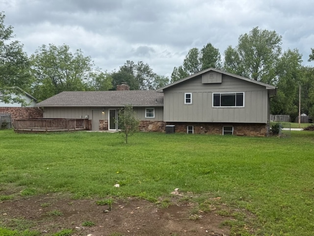 1902 W Granite St, Siloam Springs, AR 72761 - rear view of house with a chimney, central AC unit, a deck, and a lawn