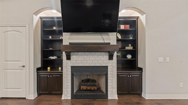 809 Ravine St, Cave Springs, AR 72718 - unfurnished living room featuring dark wood finished floors, baseboards, and a fireplace