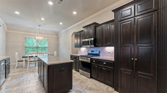 809 Ravine St, Cave Springs, AR 72718 - kitchen with appliances with stainless steel finishes, a chandelier, decorative backsplash, a center island, and light stone countertops