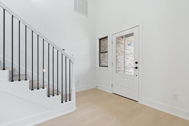 7101 SW Basswood Ave, Bentonville, AR 72713 - entryway with wood finished floors, stairway, baseboards, and a high ceiling