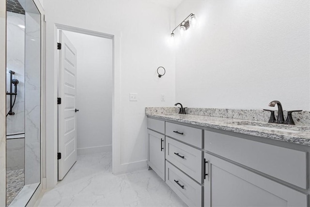 7101 SW Basswood Ave, Bentonville, AR 72713 - bathroom with marble look tile flooring, a marble finish shower, double vanity, and baseboards