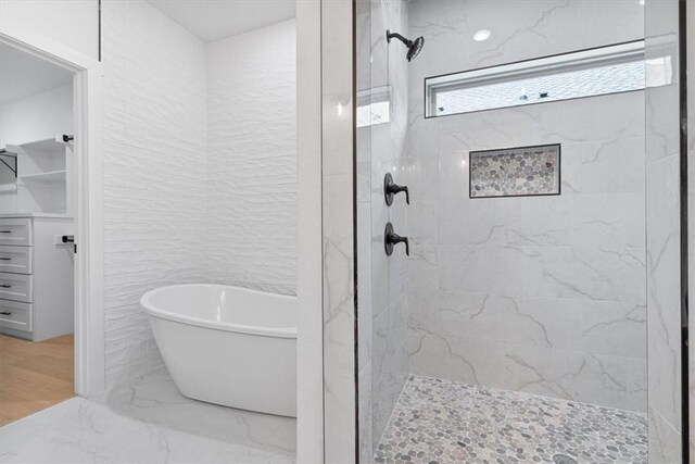 7101 SW Basswood Ave, Bentonville, AR 72713 - full bath featuring a freestanding tub, tiled shower, and marble tiled flooring