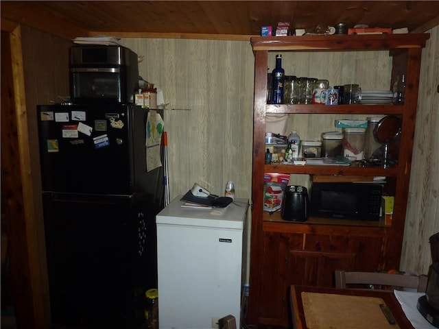 396 Dawn Light Dr, Western Grove, AR 72675 - kitchen featuring black appliances, wood ceiling, and wood walls