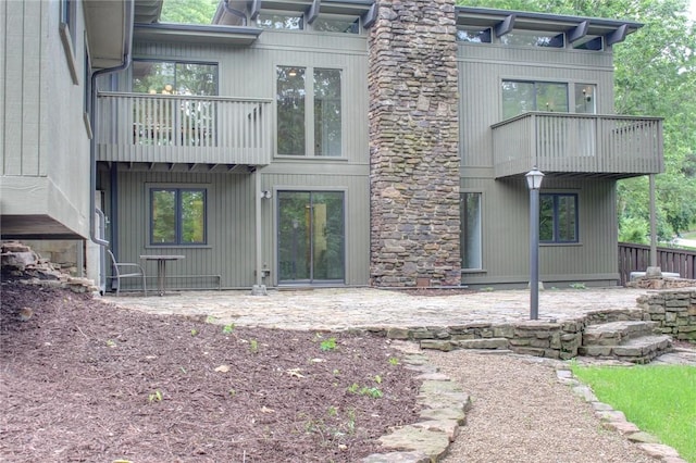 1588 N Tanglebriar Ln, Fayetteville, AR 72701 - rear view of property featuring a balcony and a patio
