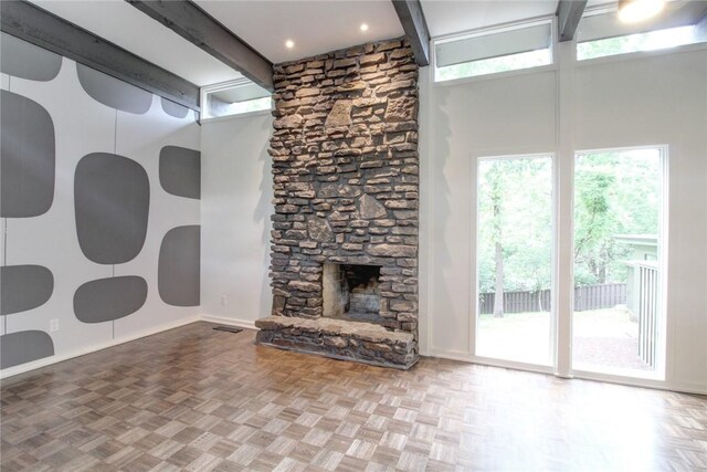 1588 N Tanglebriar Ln, Fayetteville, AR 72701 - unfurnished living room with a towering ceiling, beam ceiling, baseboards, and a fireplace