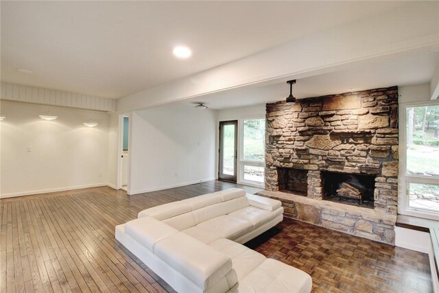 1588 N Tanglebriar Ln, Fayetteville, AR 72701 - living area with healthy amount of natural light, a fireplace, baseboards, and wood finished floors