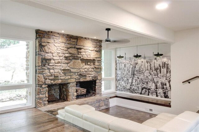 1588 N Tanglebriar Ln, Fayetteville, AR 72701 - living room featuring wood finished floors, a stone fireplace, and baseboards