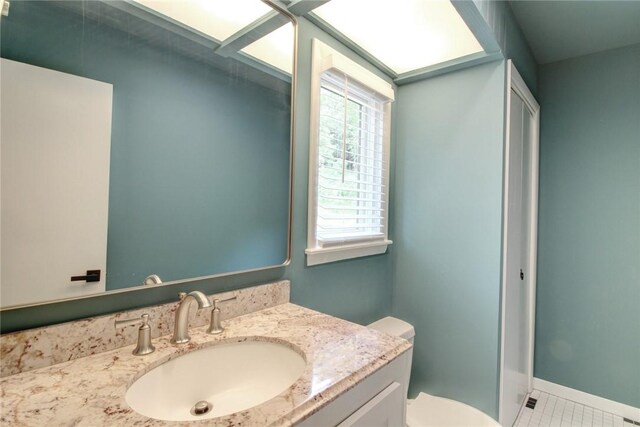 1588 N Tanglebriar Ln, Fayetteville, AR 72701 - bathroom featuring vanity, toilet, tile patterned flooring, and baseboards