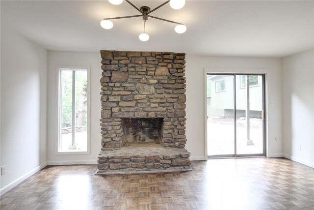 1588 N Tanglebriar Ln, Fayetteville, AR 72701 - unfurnished living room featuring plenty of natural light, a fireplace, and baseboards