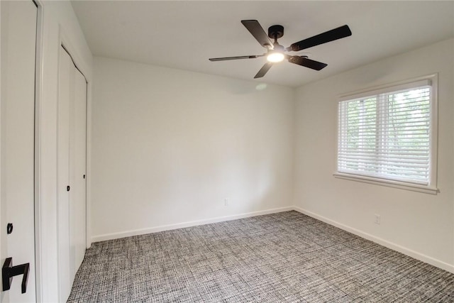 1588 N Tanglebriar Ln, Fayetteville, AR 72701 - unfurnished bedroom featuring carpet floors, a closet, baseboards, and ceiling fan