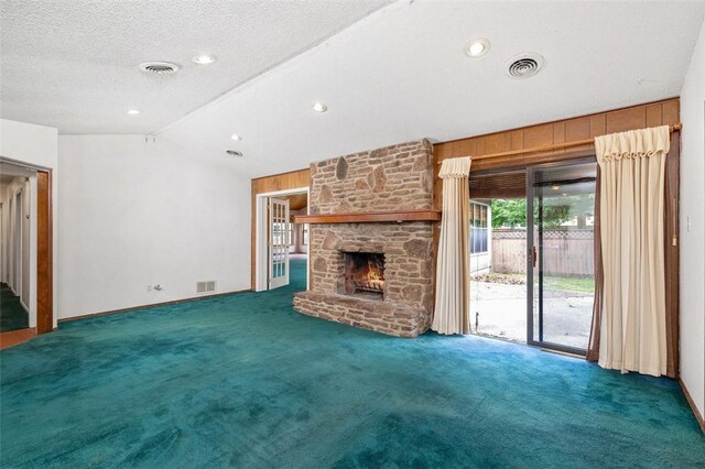 1719 Ridgeview Dr, Springdale, AR 72762 - unfurnished living room with carpet, lofted ceiling, a fireplace, wooden walls, and baseboards