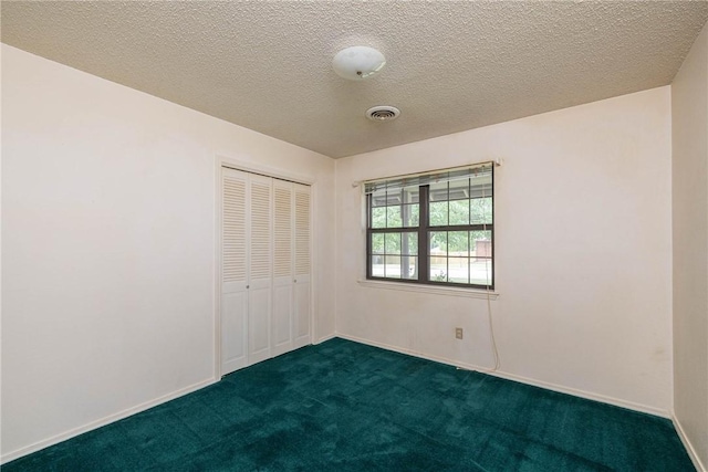 1719 Ridgeview Dr, Springdale, AR 72762 - unfurnished bedroom with dark colored carpet, a closet, a textured ceiling, and baseboards