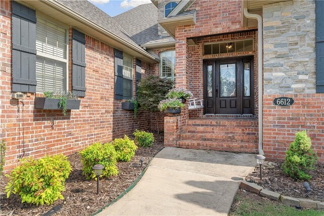 6612 W Inverness Dr, Rogers, AR 72758 - property entrance with a shingled roof and brick siding