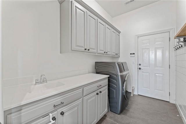 6612 W Inverness Dr, Rogers, AR 72758 - laundry area with cabinet space, light tile patterned floors, and separate washer and dryer