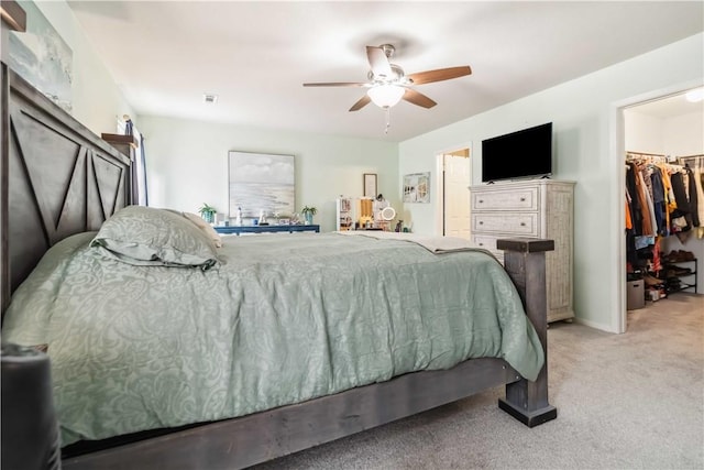 1017 Richland Creek Ave, Elkins, AR 72727 - bedroom featuring a walk in closet, light carpet, ceiling fan, and a closet