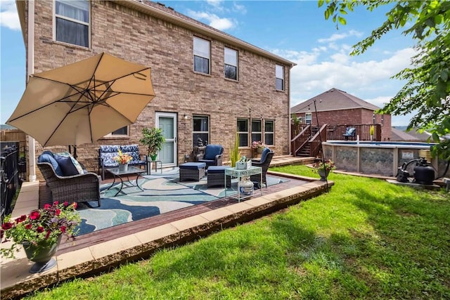 1017 Richland Creek Ave, Elkins, AR 72727 - back of house with a lawn, outdoor lounge area, a wooden deck, and brick siding