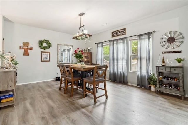 1017 Richland Creek Ave, Elkins, AR 72727 - dining area featuring wood finished floors, baseboards, and a chandelier