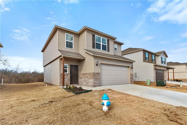 851 E Sparrow Cir, Fayetteville, AR 72701 - view of front facade featuring brick siding, a garage, concrete driveway, and roof with shingles