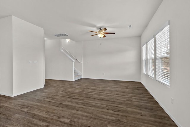 851 E Sparrow Cir, Fayetteville, AR 72701 - unfurnished living room featuring a ceiling fan, stairway, dark wood-style floors, and baseboards
