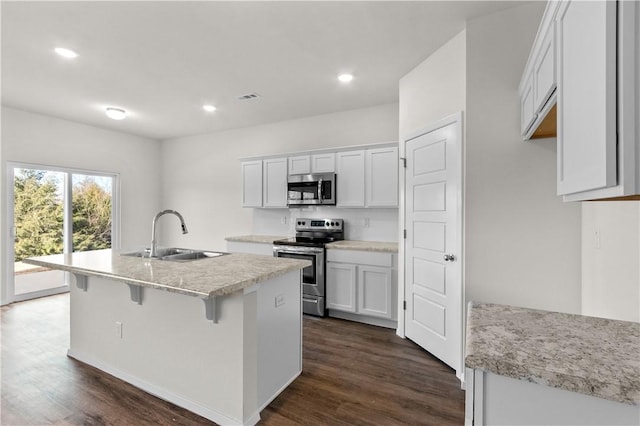 851 E Sparrow Cir, Fayetteville, AR 72701 - kitchen with appliances with stainless steel finishes, a sink, dark wood-type flooring, white cabinetry, and recessed lighting