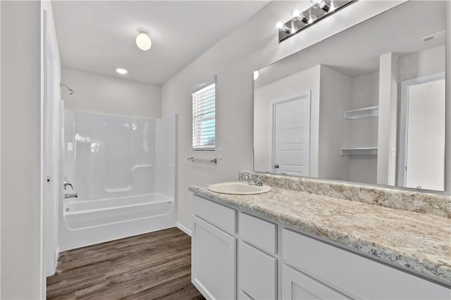 851 E Sparrow Cir, Fayetteville, AR 72701 - bathroom with vanity, bathtub / shower combination, wood finished floors, and baseboards