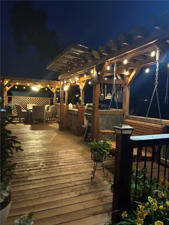 4158 N Rocky Ridge Trl, Rogers, AR 72756 - deck at night with a pergola and outdoor dining area