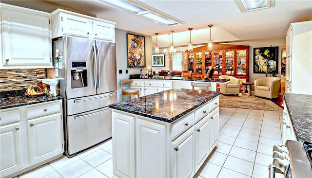 811 E Township St, Fayetteville, AR 72703 - kitchen with appliances with stainless steel finishes, light tile patterned flooring, a center island, and tasteful backsplash