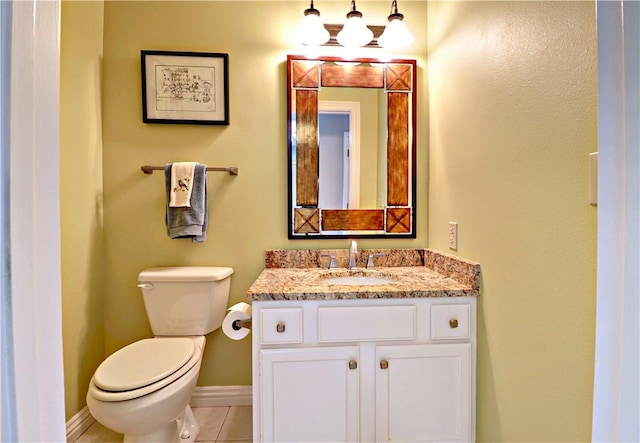 811 E Township St, Fayetteville, AR 72703 - half bathroom with vanity, toilet, baseboards, and tile patterned flooring