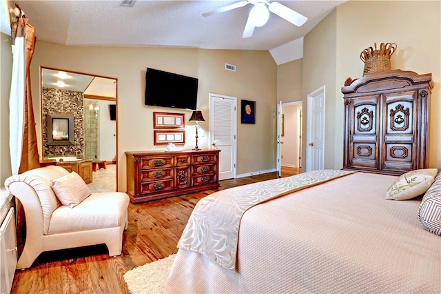 811 E Township St, Fayetteville, AR 72703 - bedroom with light wood-style flooring, baseboards, connected bathroom, ceiling fan, and high vaulted ceiling