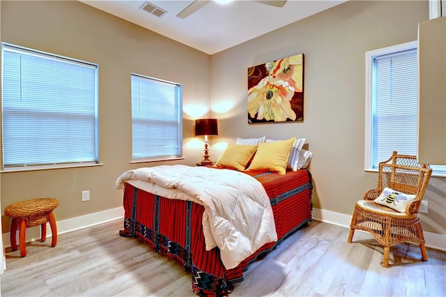 811 E Township St, Fayetteville, AR 72703 - bedroom featuring wood finished floors, baseboards, multiple windows, and ceiling fan